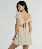 Essential for vacations or summer days, the Flirt And Twirl Puff Sleeve Tie-Back Skater Dress is a sundress or milkmaid dress with sleek and flirty details.