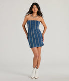 Essential for vacations or summer days, the Tell Me About It Stud Strapless Denim Mini Dress is a sundress or milkmaid dress with sleek and flirty details.