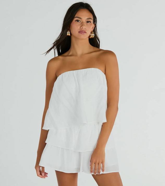 The Poolside Vacay Strapless Ruffled Romper is an elevated one-piece that blends sleek sophistication with playful charm, perfect for nailing casual or formal outfits.