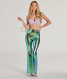 Iridescent flare pants with a mermaid scale print styled for Windsor's mermaid costume with a shell bra with hanging faux pearls, a shell-shaped clear clutch, and white heels.