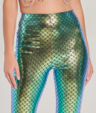 Front view of mermaid flare pants showcasing the iridescent foiled finish of the scale print with texture and vibrant colors.