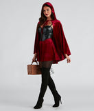 Lil' Red Adult Costume from Windsor features a black corset top, a red velvet hooded cape, tights, and black faux suede lace-up boots.